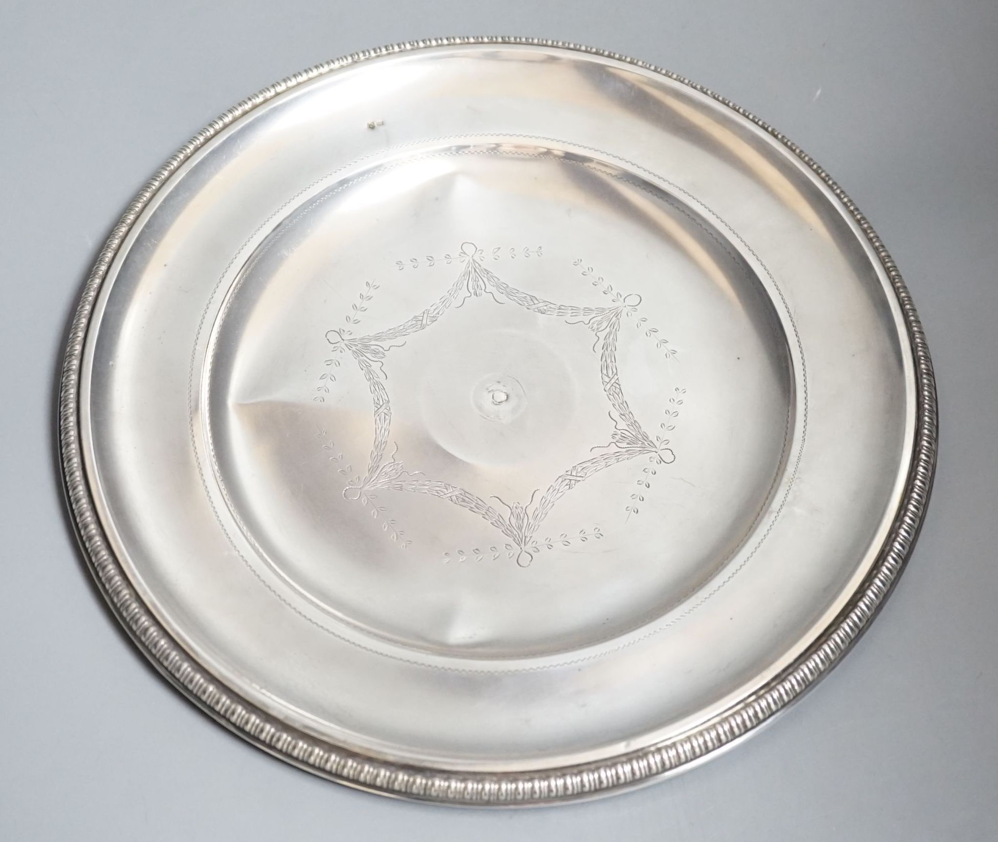 An Austro-Hungarian white metal circular dish with engraved swag decoration, 30cm, 11.5oz.